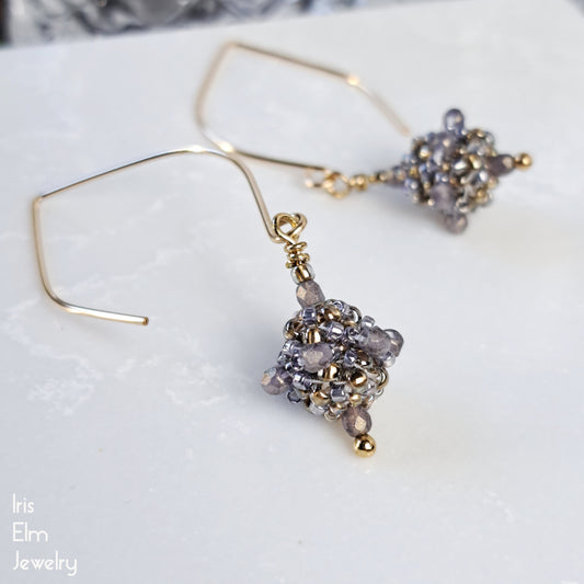 Gold and light purple Czech glass beaded drop earrings with goldfilled marquise ear wires on a white surface with 'Iris Elm Jewelry' branding.