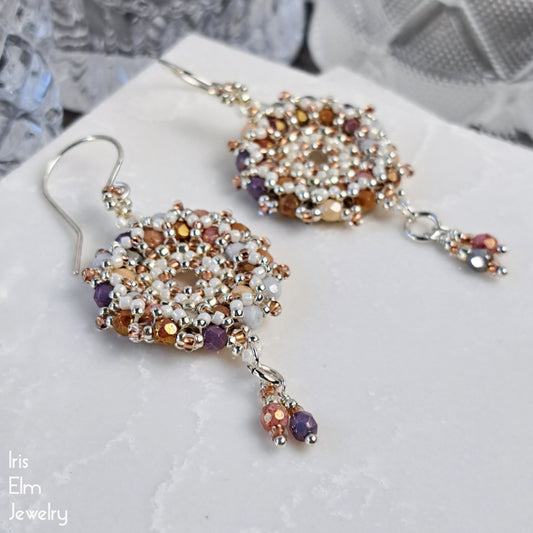Beaded circle flower hoop glass dangle earrings on a white surface with 'Iris Elm Jewelry' branding.