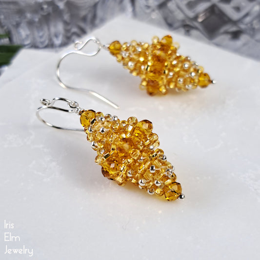 Yellow faceted glass beaded bead earrings on a white surface with 'Iris Elm Jewelry' branding.