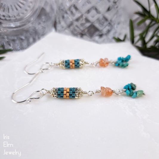 Beaded earrings with turquoise gemstone and peach sunstone beads on a white surface.