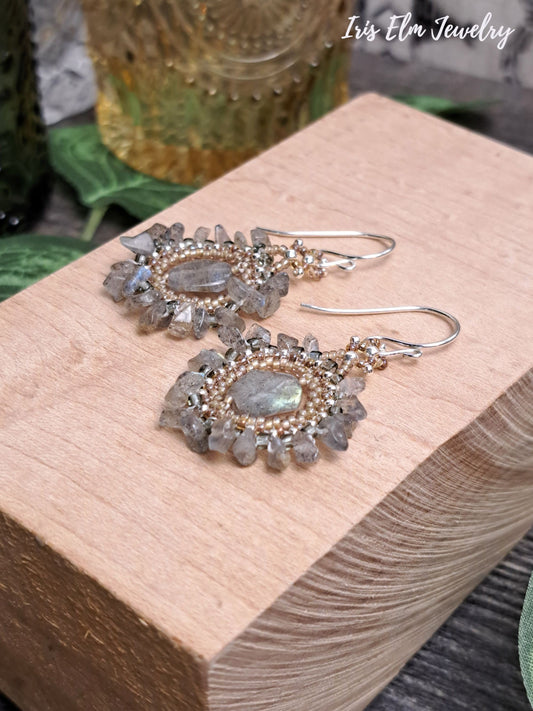 Decorative bohemian labradorite beadwork handmade earrings on a wooden block with 'Iris Elm Jewelry' branding.