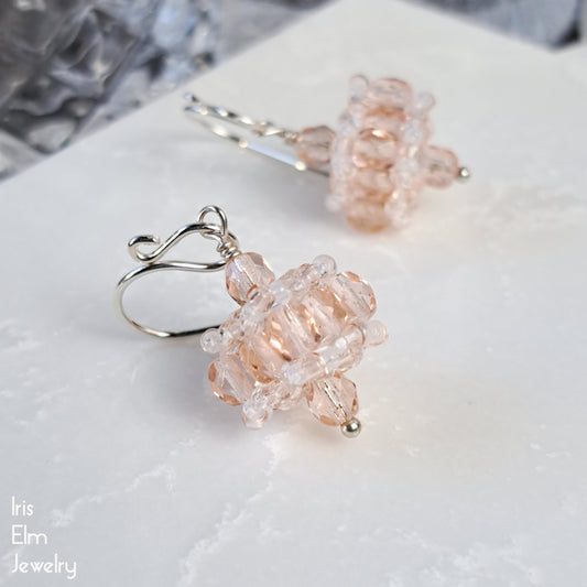 Pair of pink and clear beaded Czech glass earrings on a white surface with 'Iris Elm Jewelry' branding.