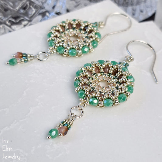 Beaded Czech glass wreath hoop earrings with turquoise and pink beads on a textured surface, featuring 'Iris Elm Jewelry' branding.