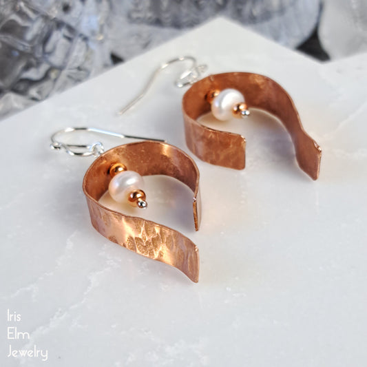 handmade hammered Copper earrings with white freshwater pearls on a white surface, branded 'Iris Elm Jewelry'.