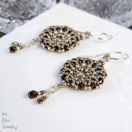 Pair of beaded Czech glass wreath brown earrings on a white surface with 'Iris Elm Jewelry' branding.
