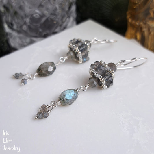 handmade sterling Silver earrings with iridescent labradorite gemstones on a white surface, featuring 'Iris Elm Jewelry' branding.