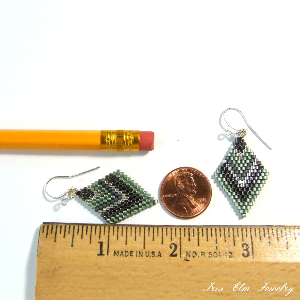 Pair of beaded diamond shape seed bead earrings next to a pencil and penny for scale, with 'Iris Elm Jewelry' branding.