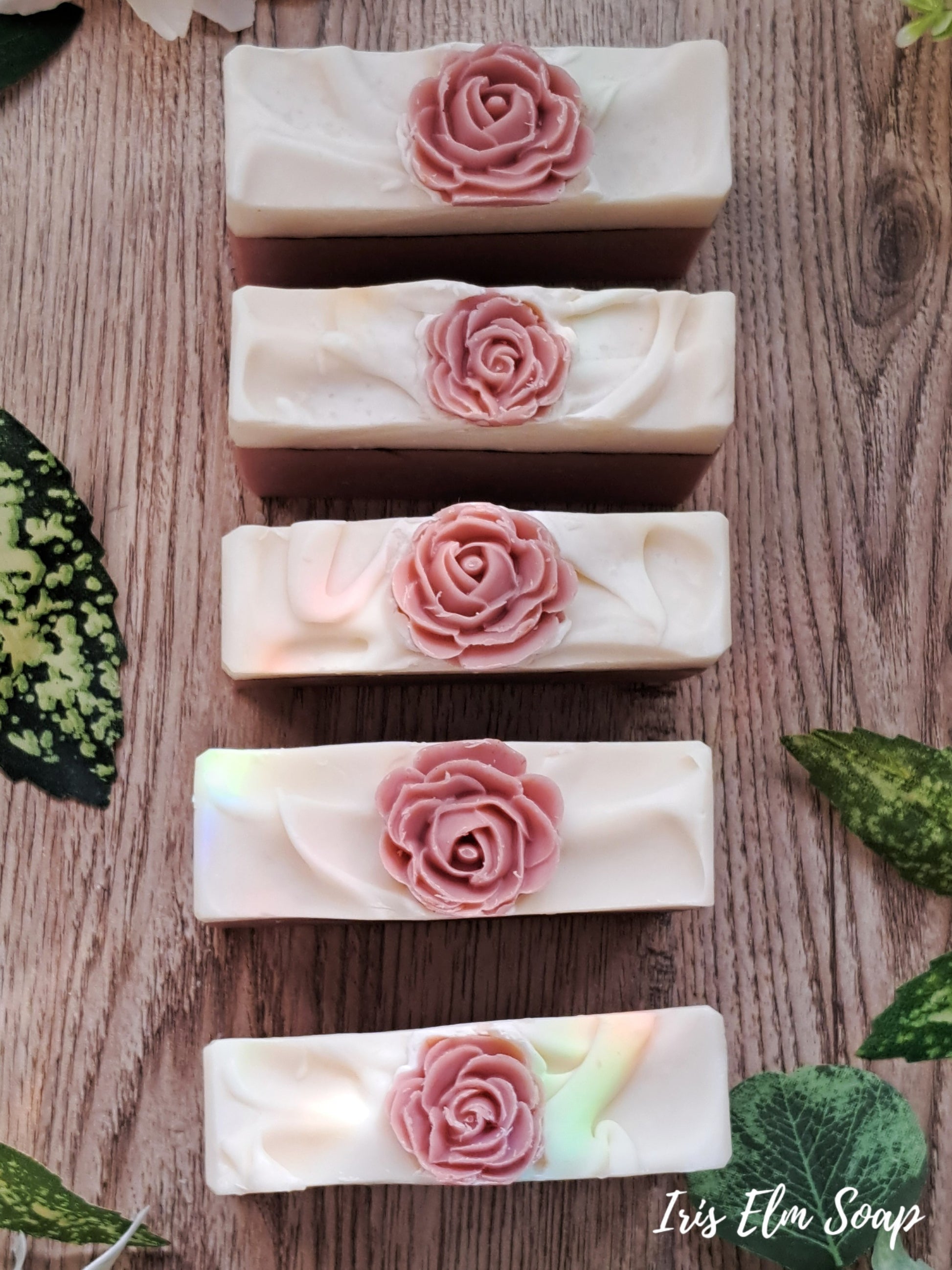a row of rose soap topped rose scented handmade soap bars