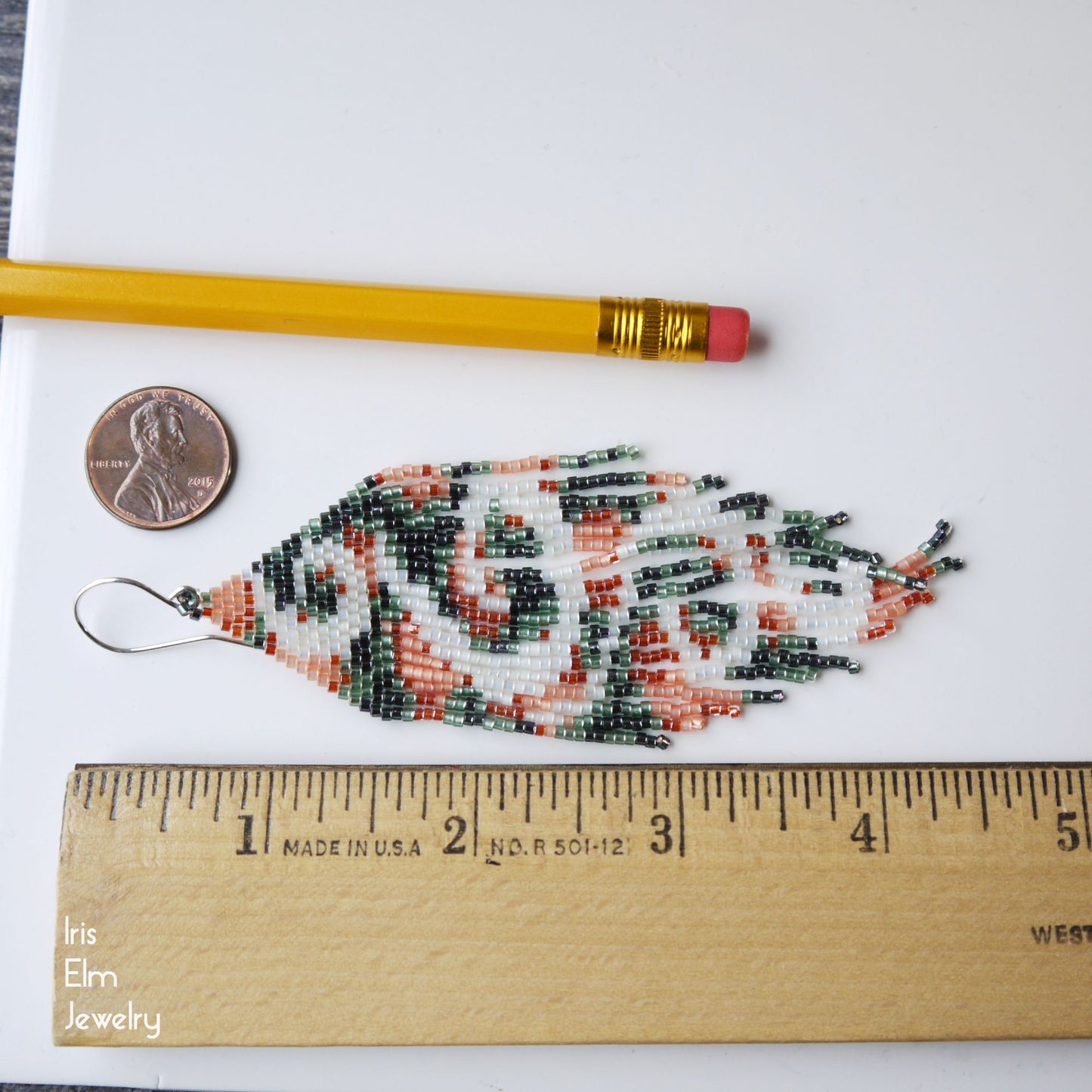 4.5 inch long fringe seed bead earrings next to a ruler, penny, and pencil on a white background