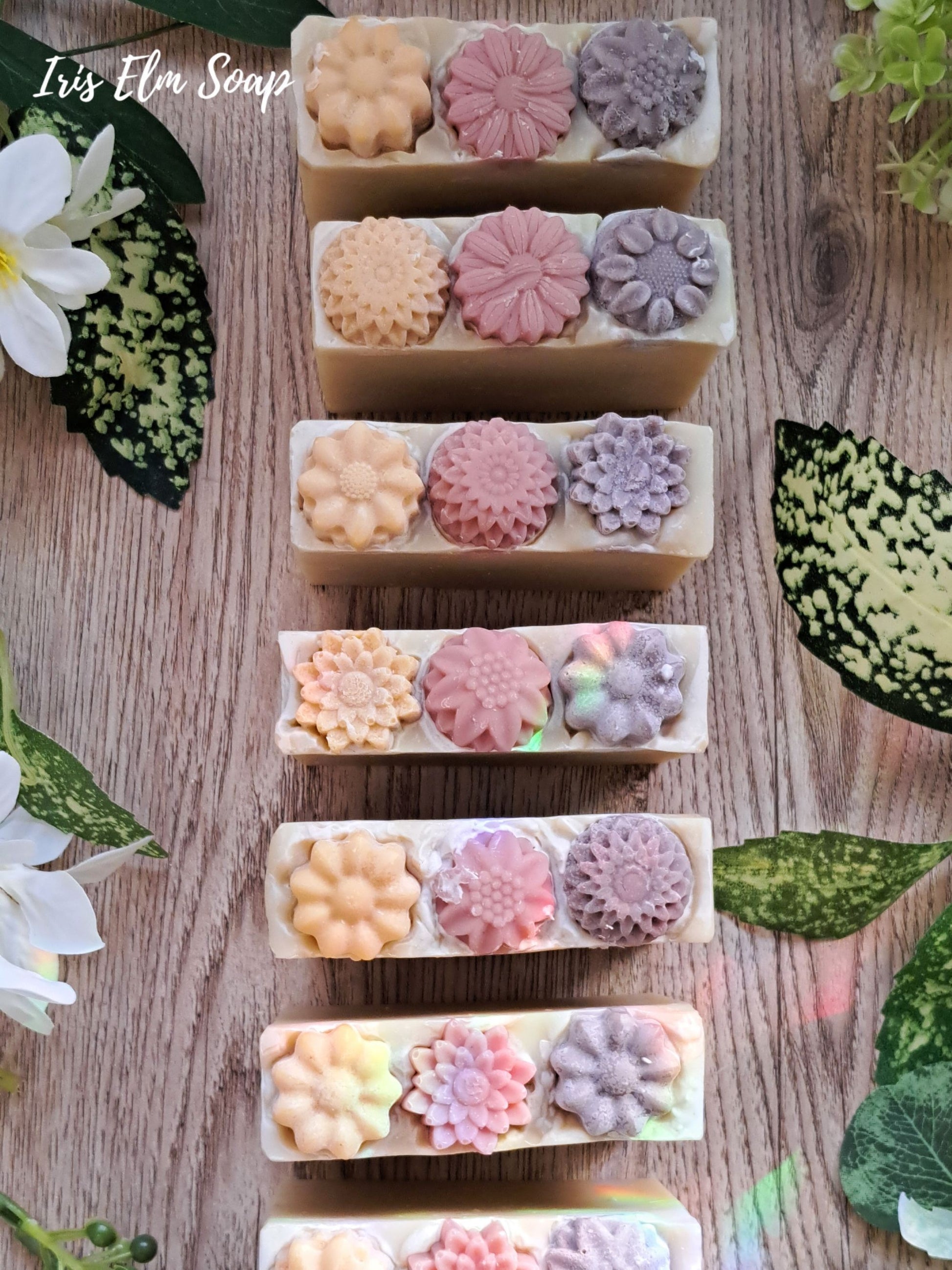 a row of floral wildflower meadow handmade soap bars with clay soap flower tops
