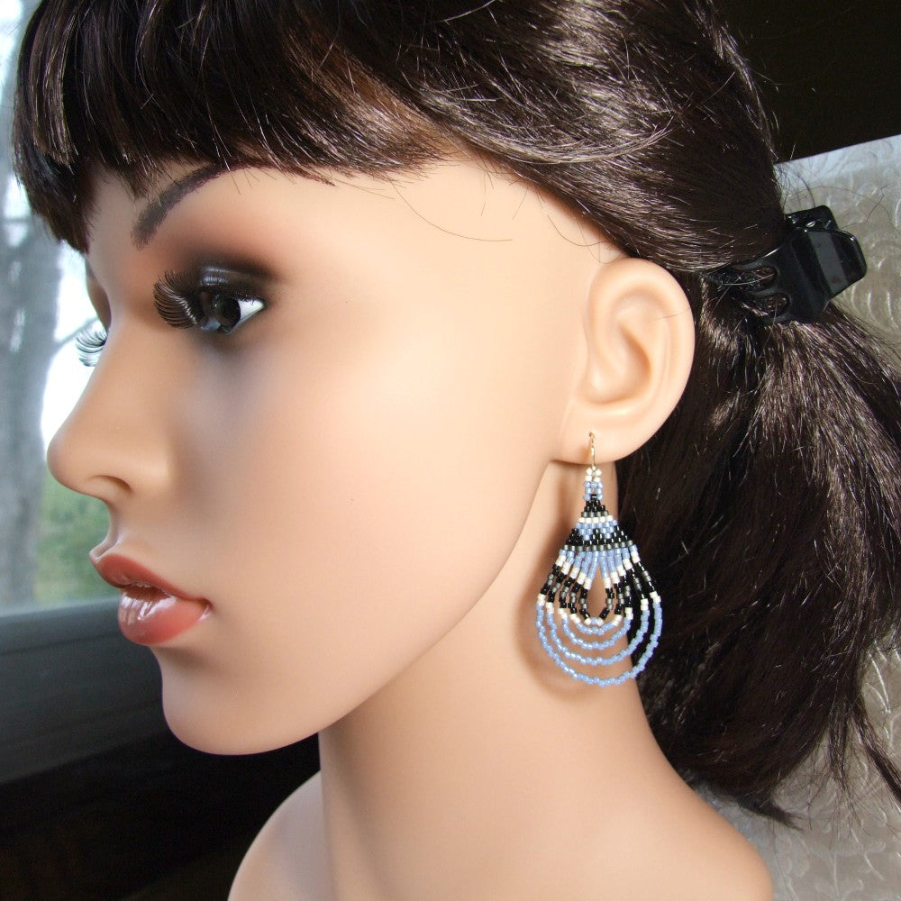 Mannequin head with dark hair and denim blue beaded earrings