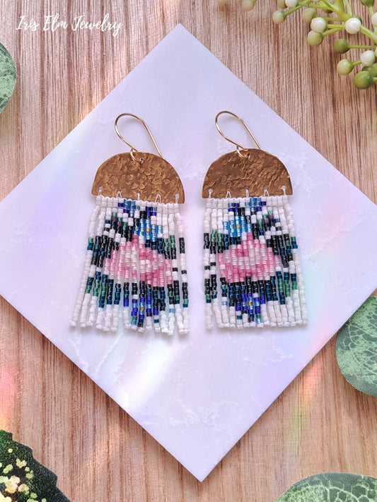 Beaded brass seed bead fringe earrings with floral pink rose design on a white card with 'Iris Elm Jewelry' branding.