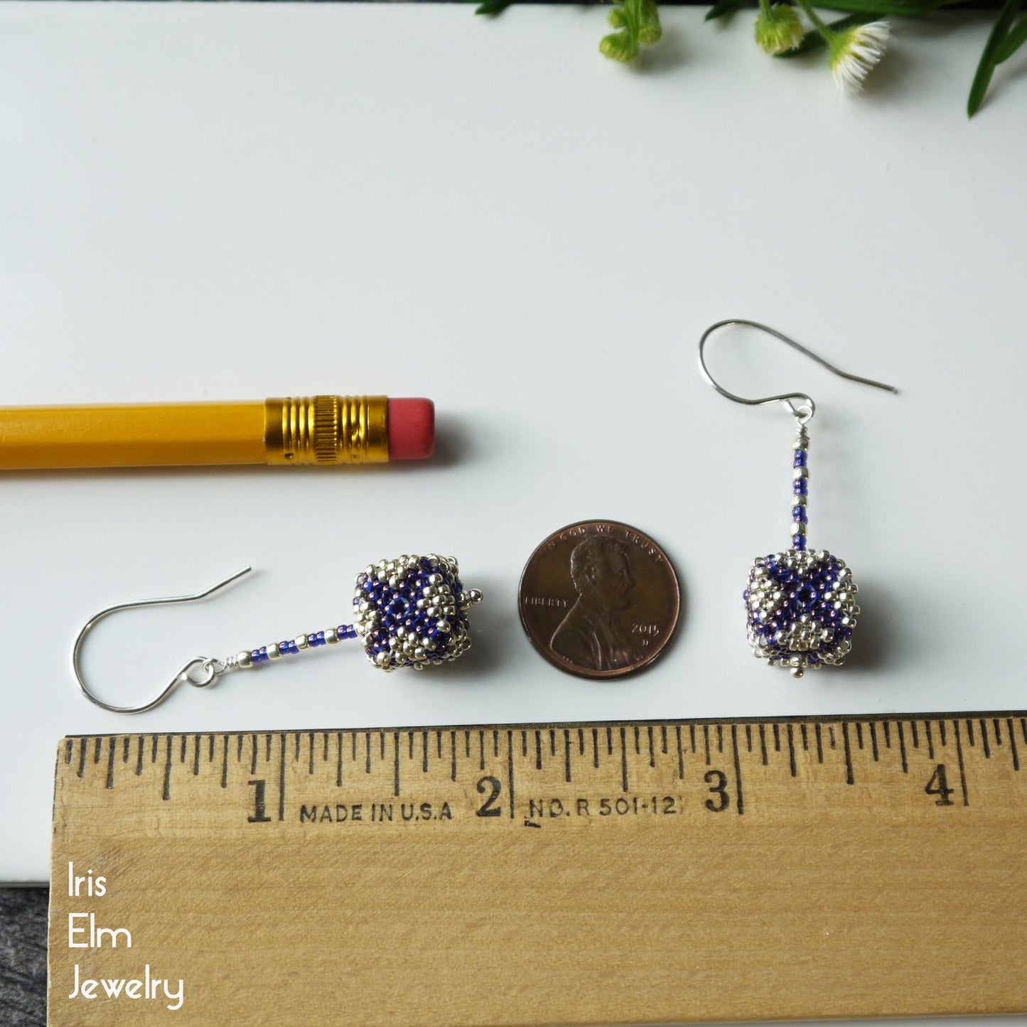 Pair of 1 and 7/8  inch long cube shaped drop earrings with a penny and pencil for scale, Iris Elm Jewelry branding visible.