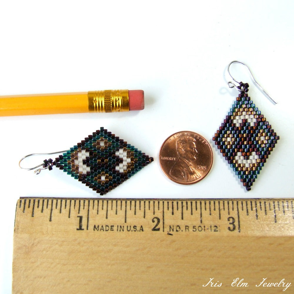 Beaded seed bead diamond shape earrings next to a penny and ruler for scale on a white background