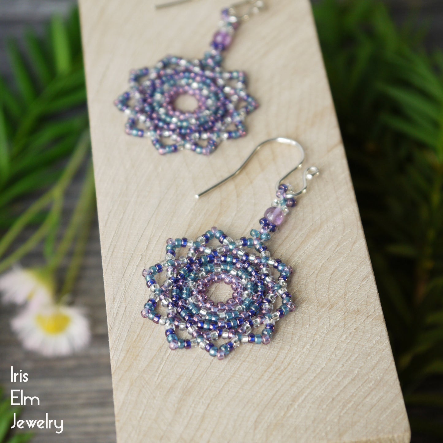 Beaded purple mandala earrings on a wooden board with 'Iris Elm Jewelry' branding.
