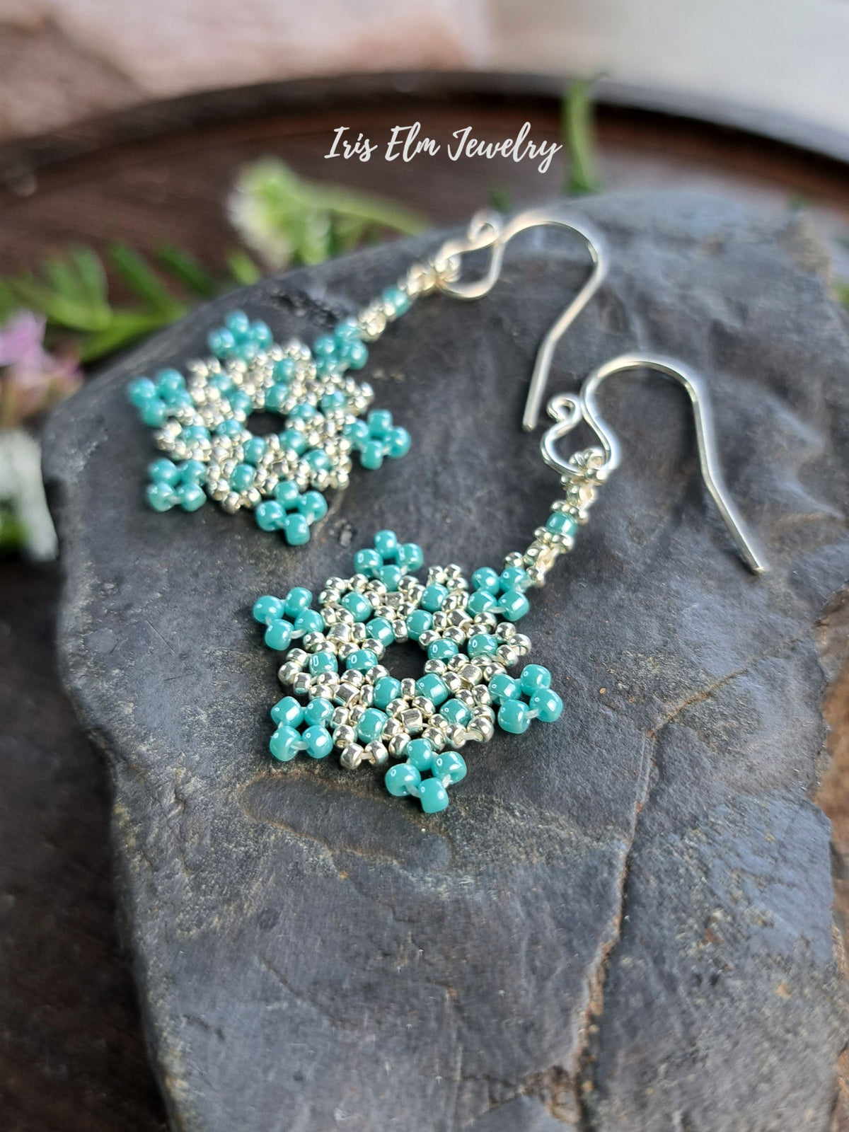 Turquoise and silver beaded dangle earrings displayed on a dark slate stone, with a white 'Iris Elm Jewelry' watermark overlay.