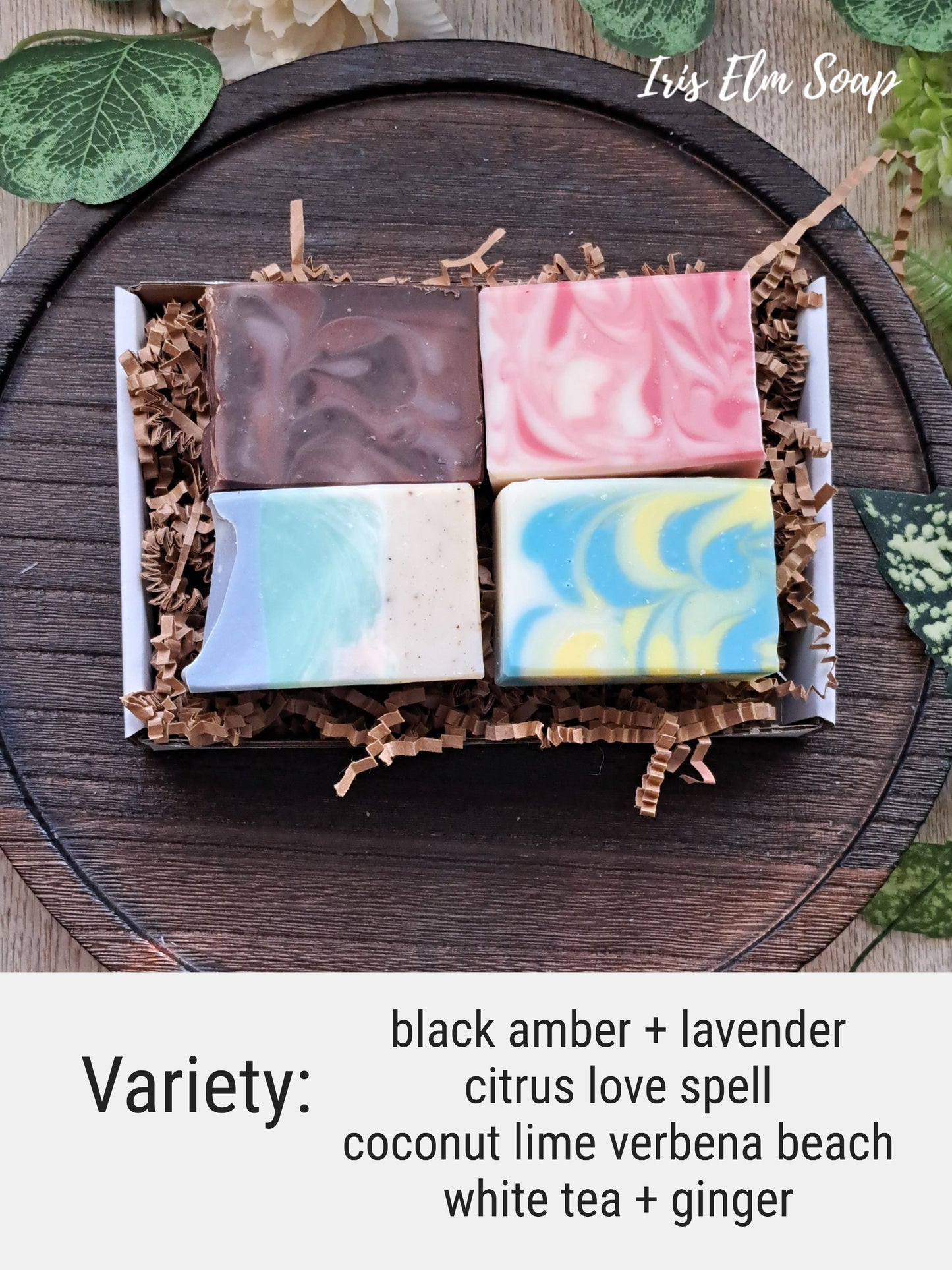 Set of four half size variety handmade soap bars in a gift box with decorative elements.