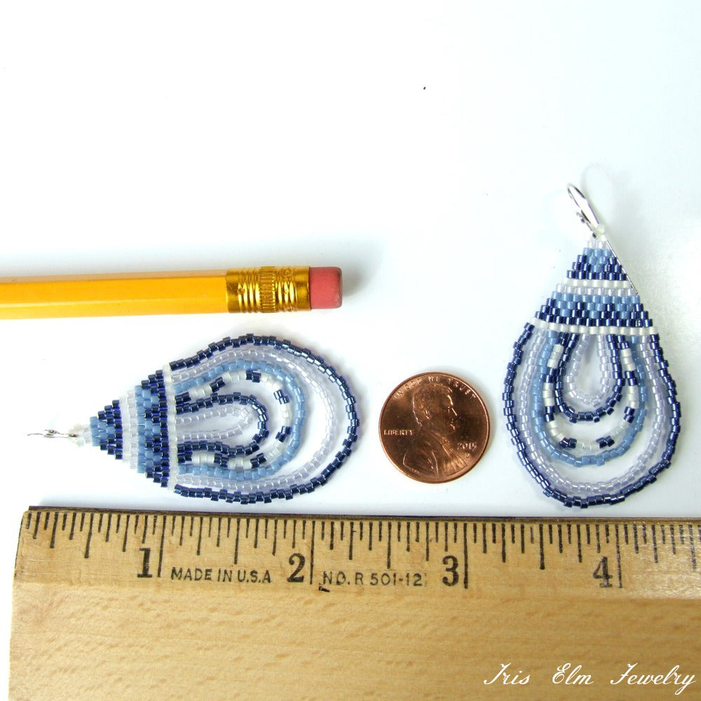 Pair of blue and white beaded teardrop earrings with a penny and pencil for scale on a white background.