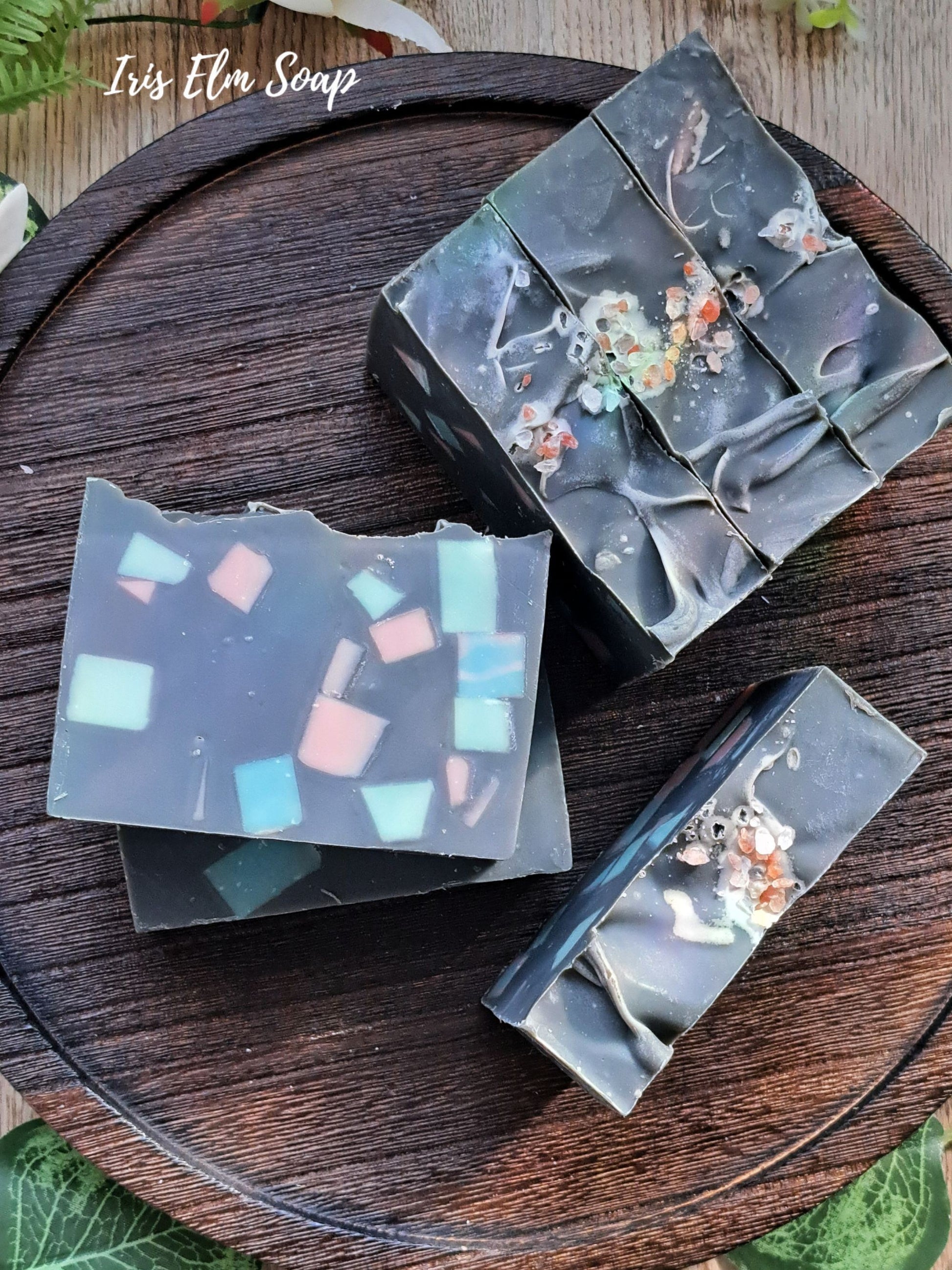 black and colorful terrazzo sea salt and orchid handmade soap bars on wooden tray with Iris Elm Soap branding