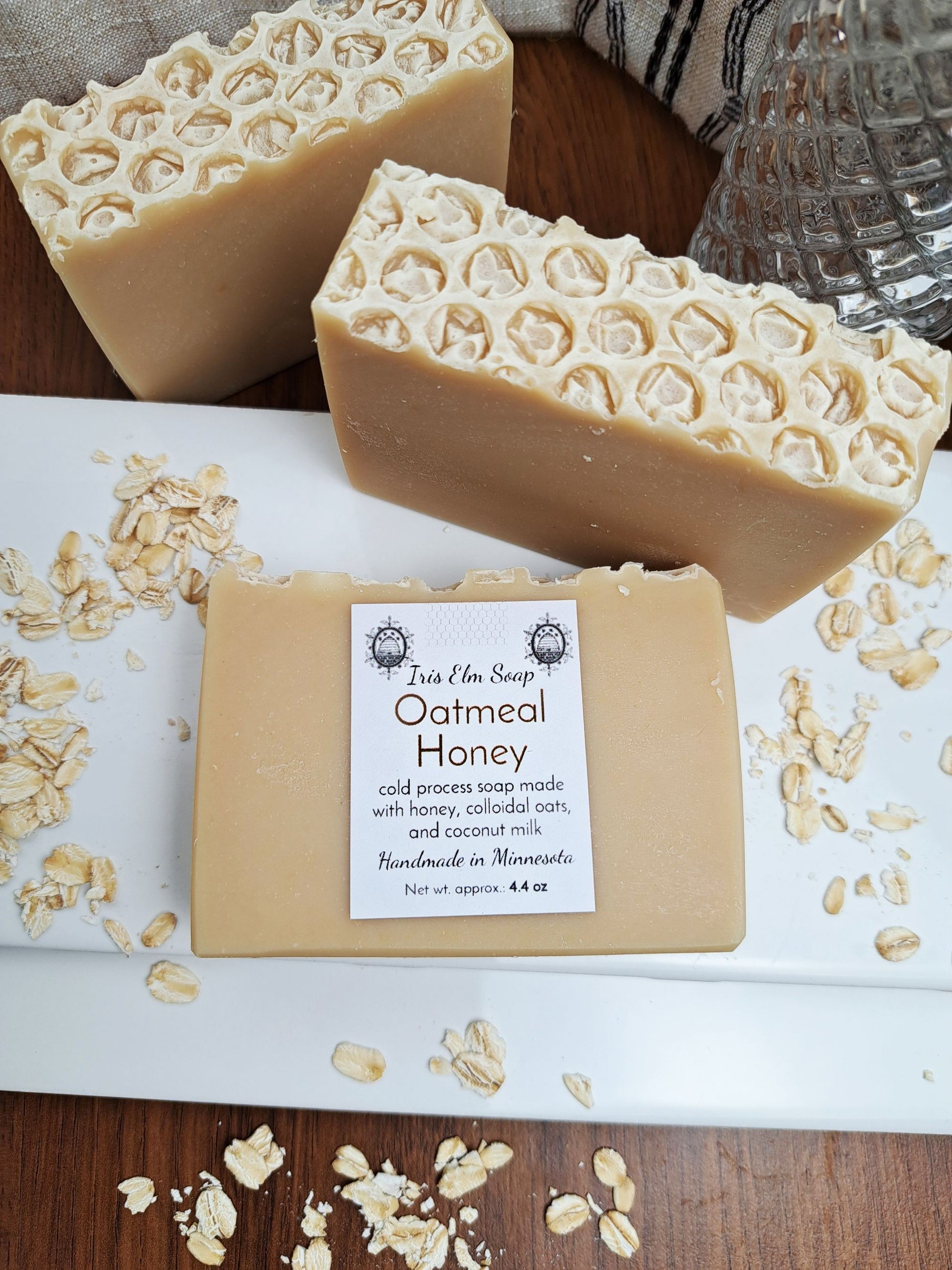 handmade Oatmeal Honey soap bar with visible oat pieces on a wooden surface