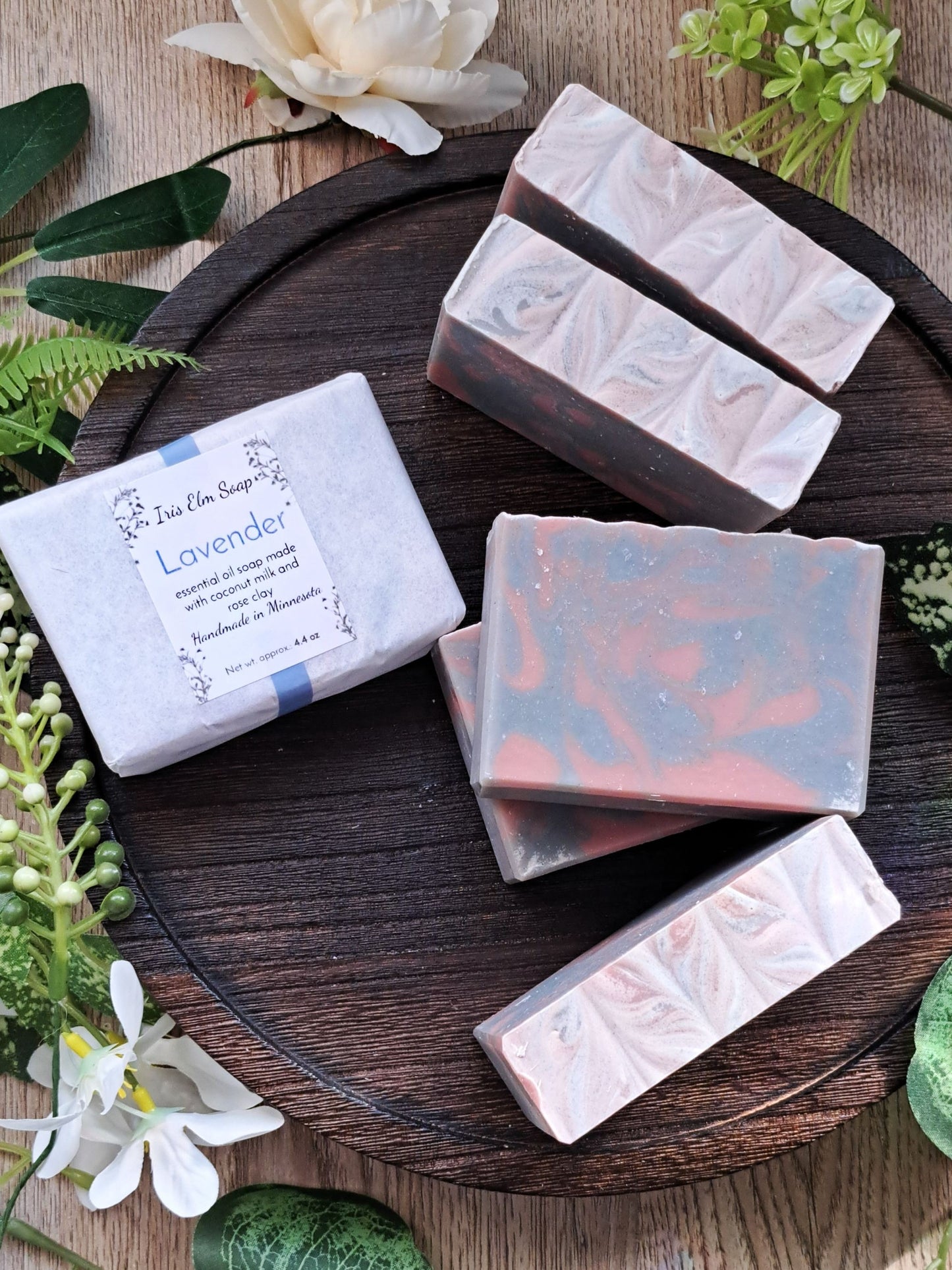 lavender essential oil Handmade soap bars on a wooden board with greenery around