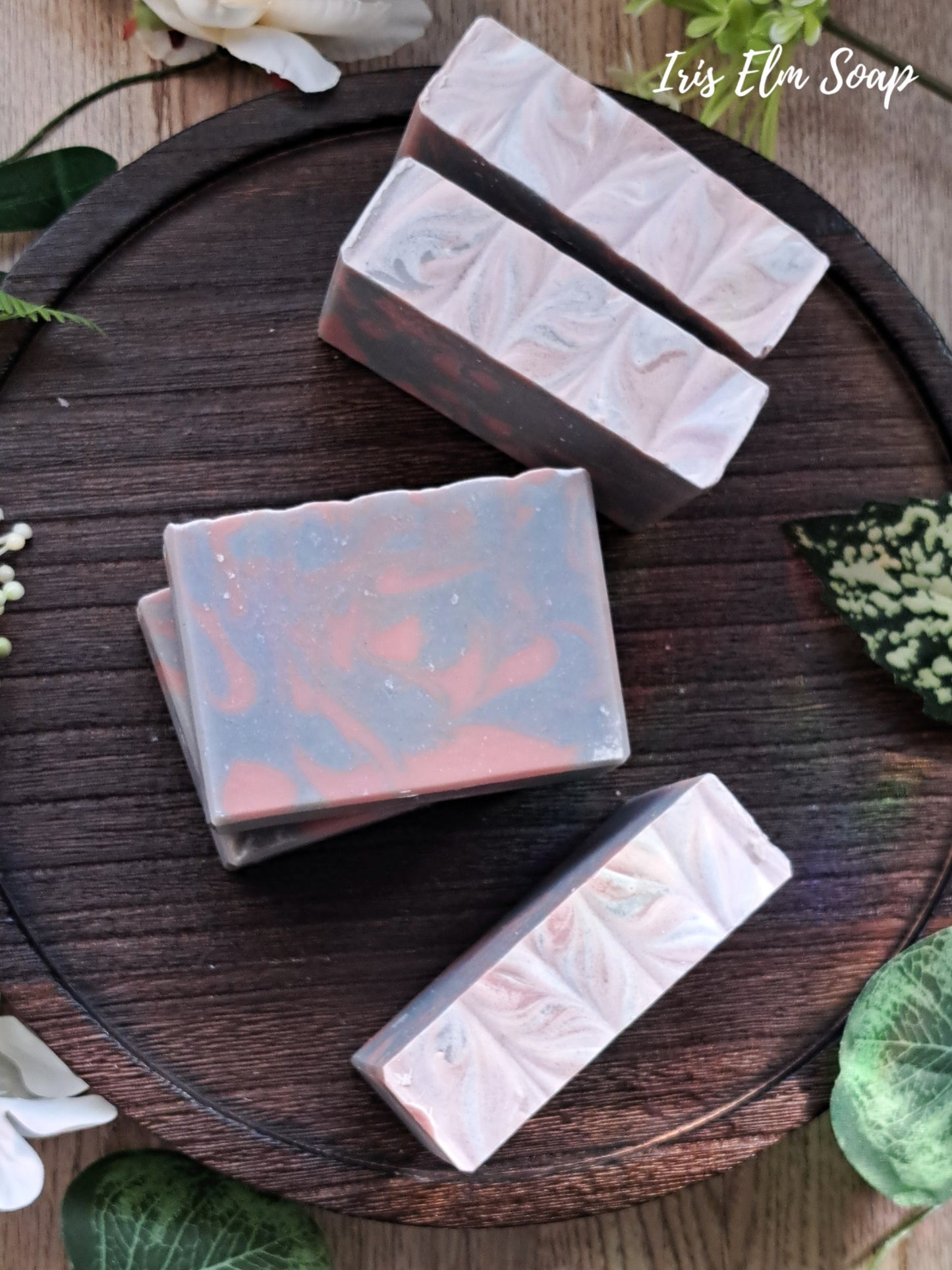 Marble-patterned lavender essential oil handmade soap bars on a wooden surface with 'Iris Elm Soap' branding.