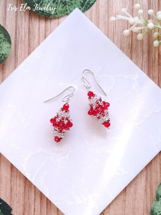 Red and clear glass vintage style beaded earrings on a white tile with 'Iris Elm Jewelry' branding.