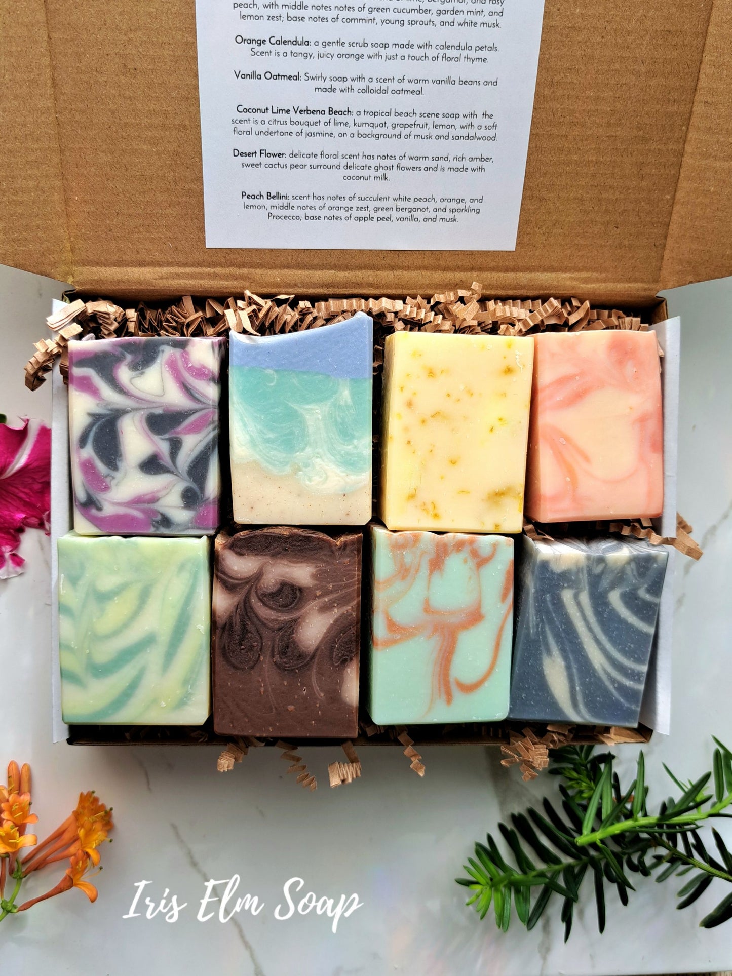 Box of Iris Elm Soap with various colored soap bars on a light background