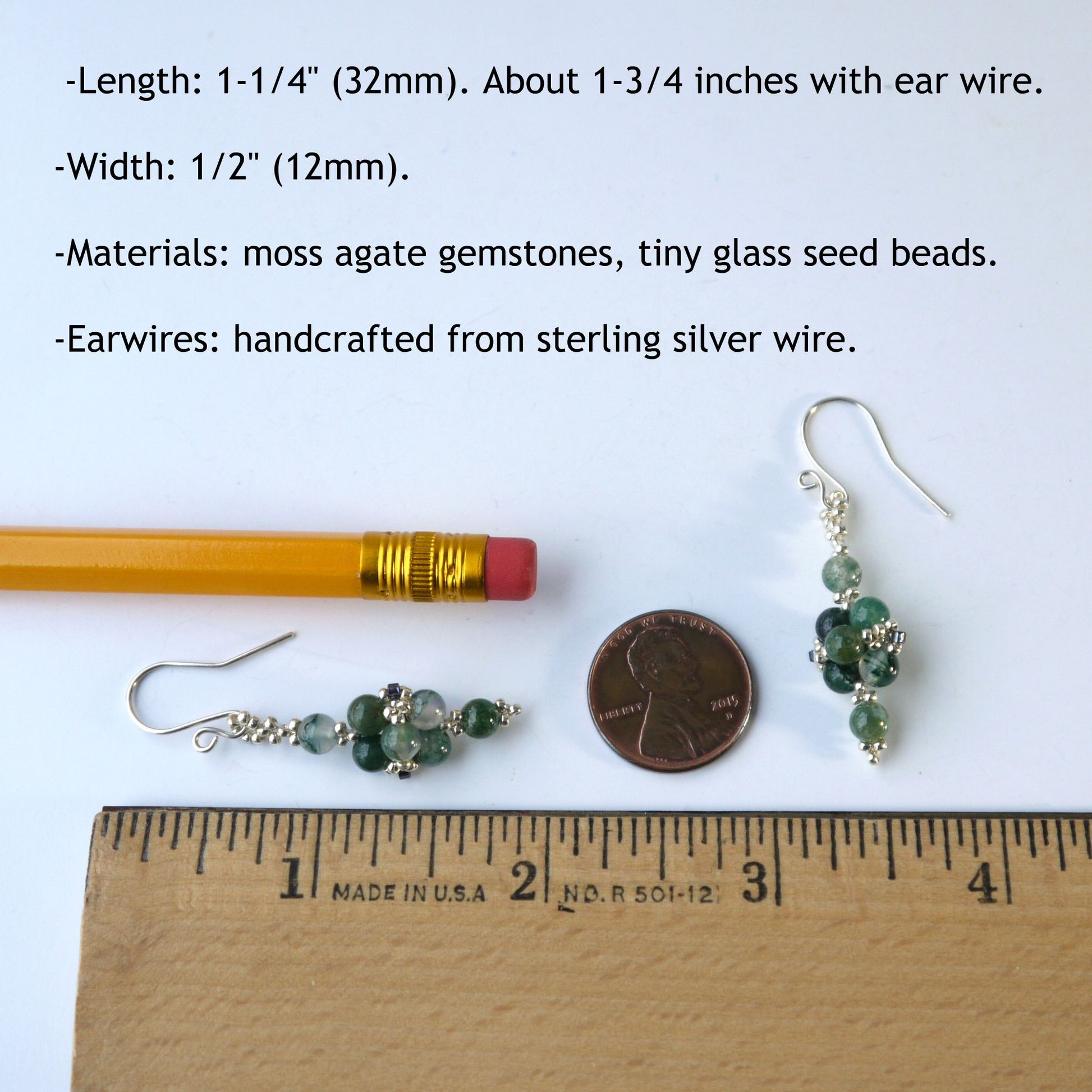 Green agate gemstone 1.75-inch-long earrings with earwires, shown with a pencil and penny for scale on a white background.