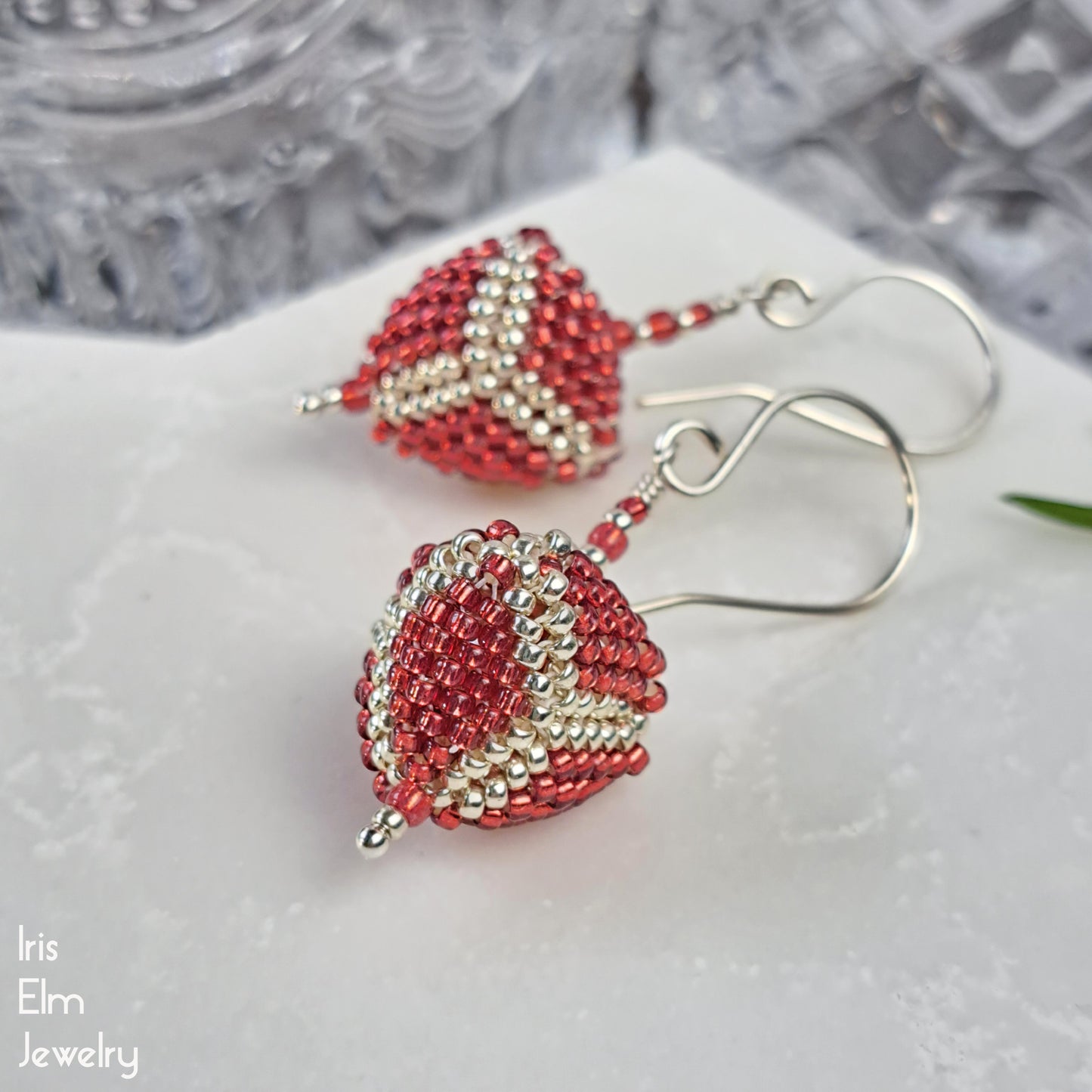 Red and silver beaded triangle glass sterling silver handmade earrings on a white surface with 'Iris Elm Jewelry' branding.