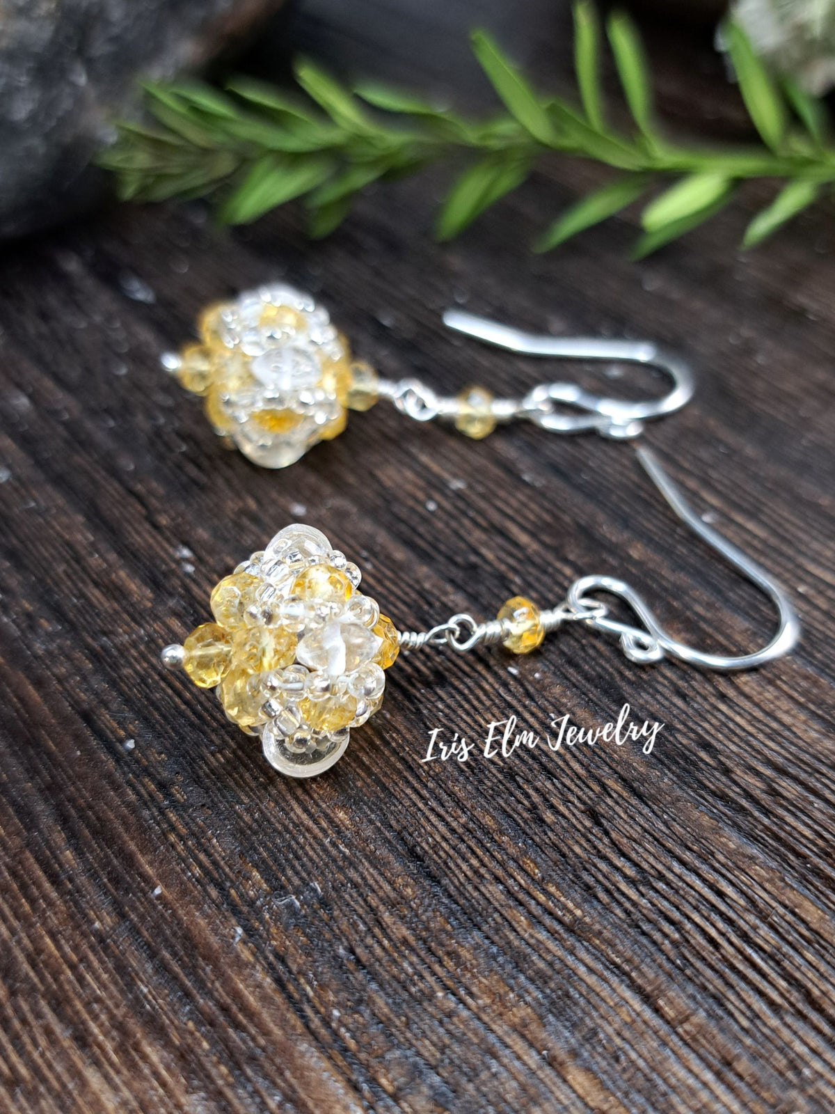 yellow citrine gemstone and quartz crystal beadwork sterling silver earrings on wooden surface with Iris Elm Jewelry 