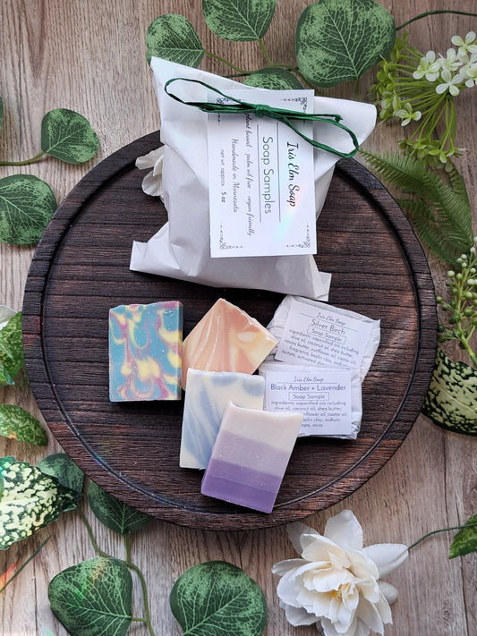 Iris Elm Soap Handmade soap bars sample pack on a wooden tray with greenery and flowers