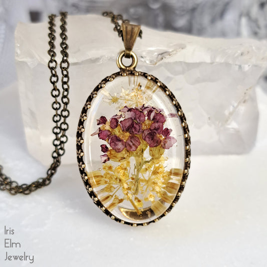 Small Oval Red, Yellow, and White Wildflower Resin Pendant Necklace - Antiqued Brass