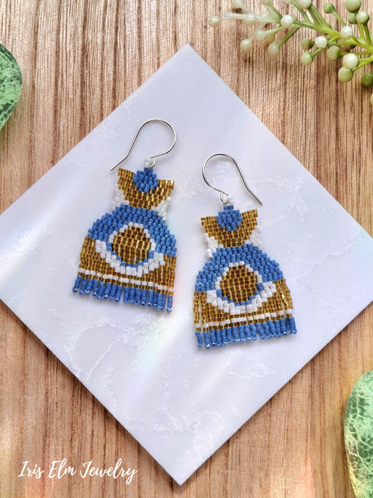 Blue and yellow modern fringe beaded earrings on a white napkin with 'Iris Elm Jewelry' branding.