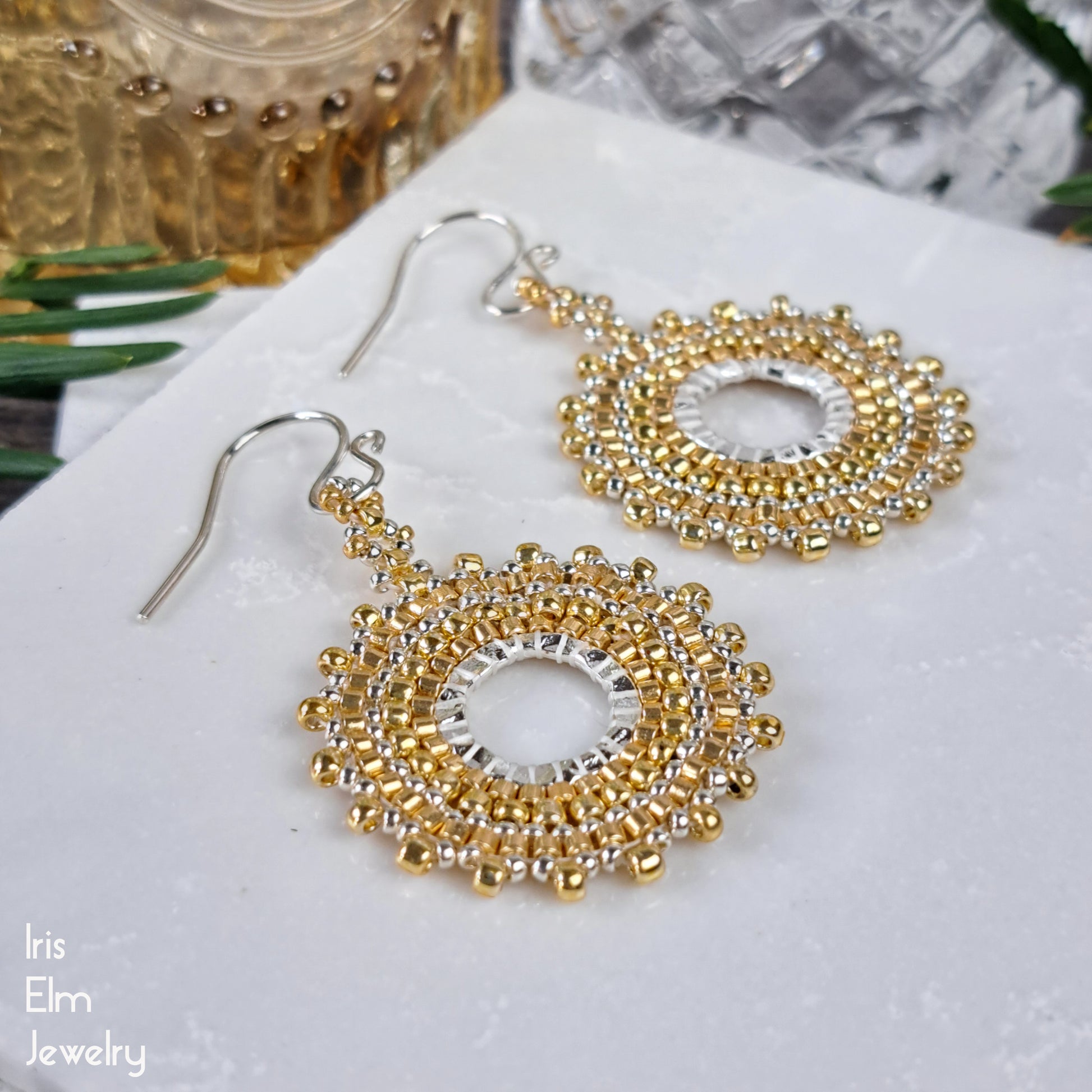 Gold and silver beaded hoop earrings on a white surface with 'Iris Elm Jewelry' branding.