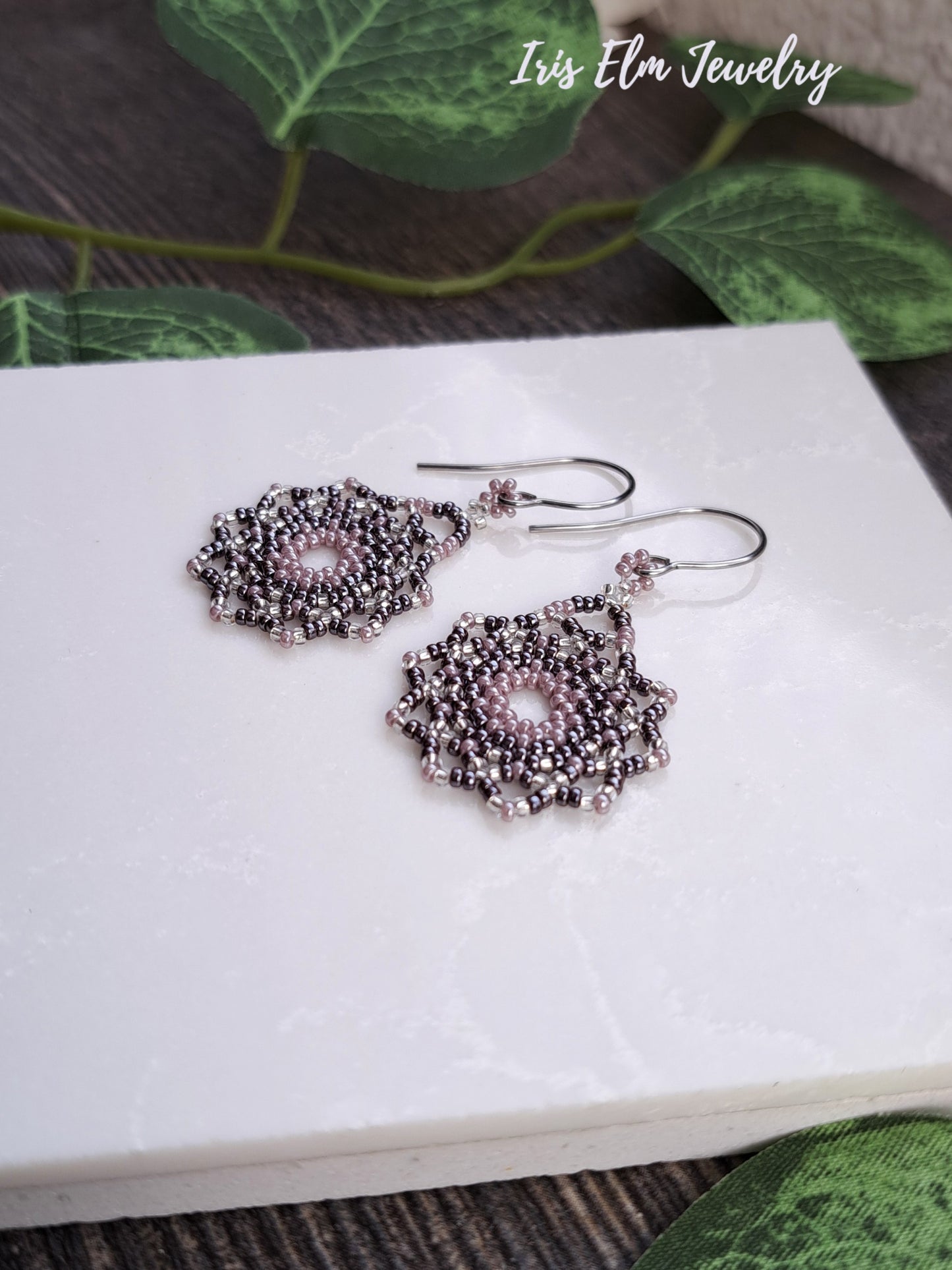 Silver beaded lilac purple seed bead mandala earrings on a white card with 'Iris Elm Jewelry' branding.