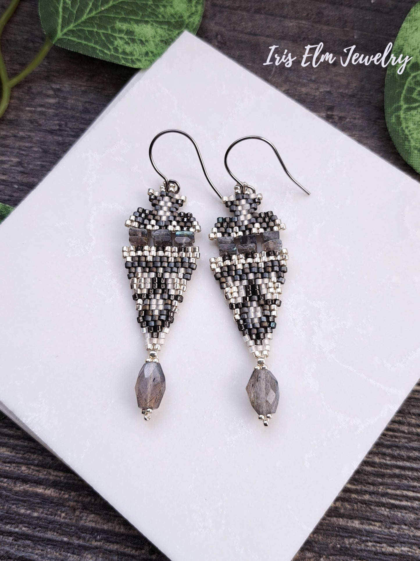 Beaded iridescent labradorite stone and seed bead boho beadwork handmade earrings on a white tile with 'Iris Elm Jewelry' branding.