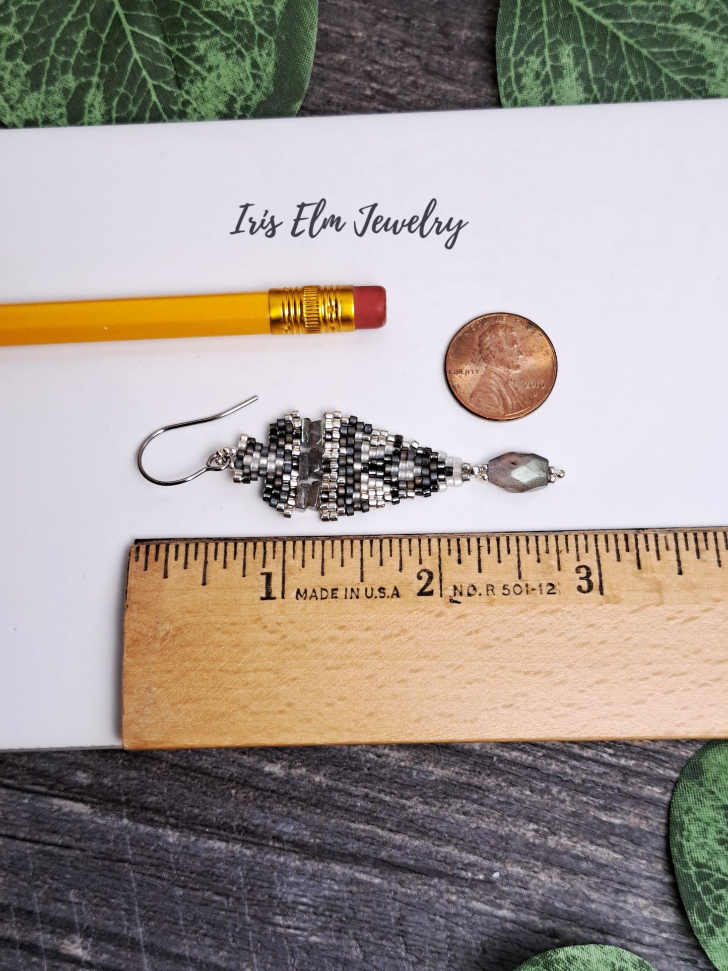 2.75 inch long labradorite beadwork earrings next to ruler and pencil for scale