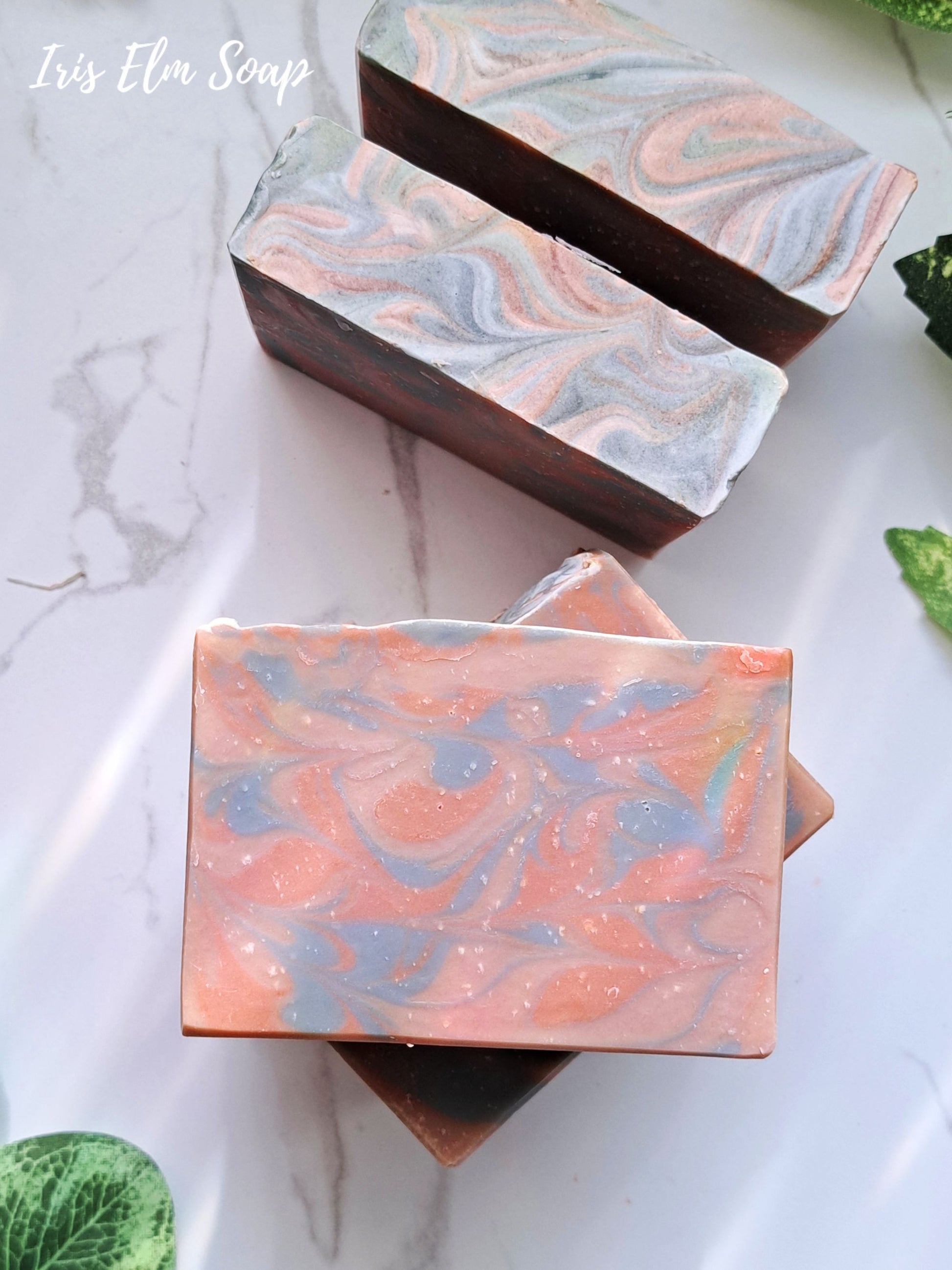 Marbled amber rosewood handmade soap bars on a marble surface with 'Iris Elm Soap' branding.