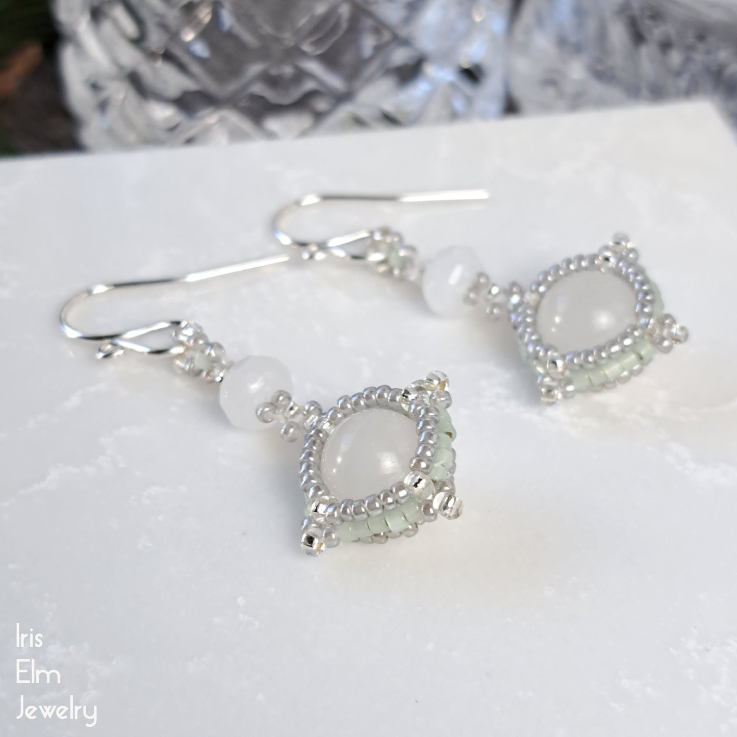 White quartz with mint green seed bead earrings on a white surface with 'Iris Elm Jewelry' branding.