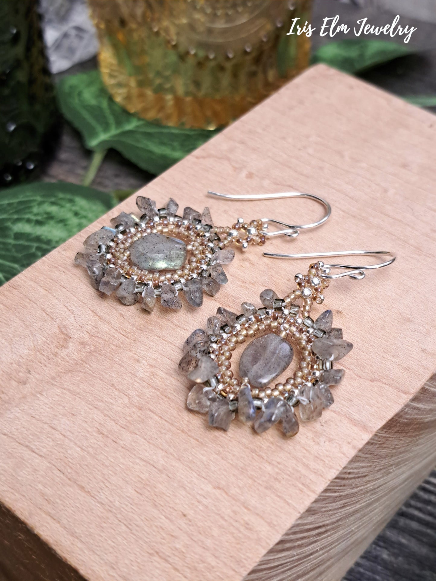 Decorative bohemian labradorite beadwork handmade earrings on a wooden block with 'Iris Elm Jewelry' branding.