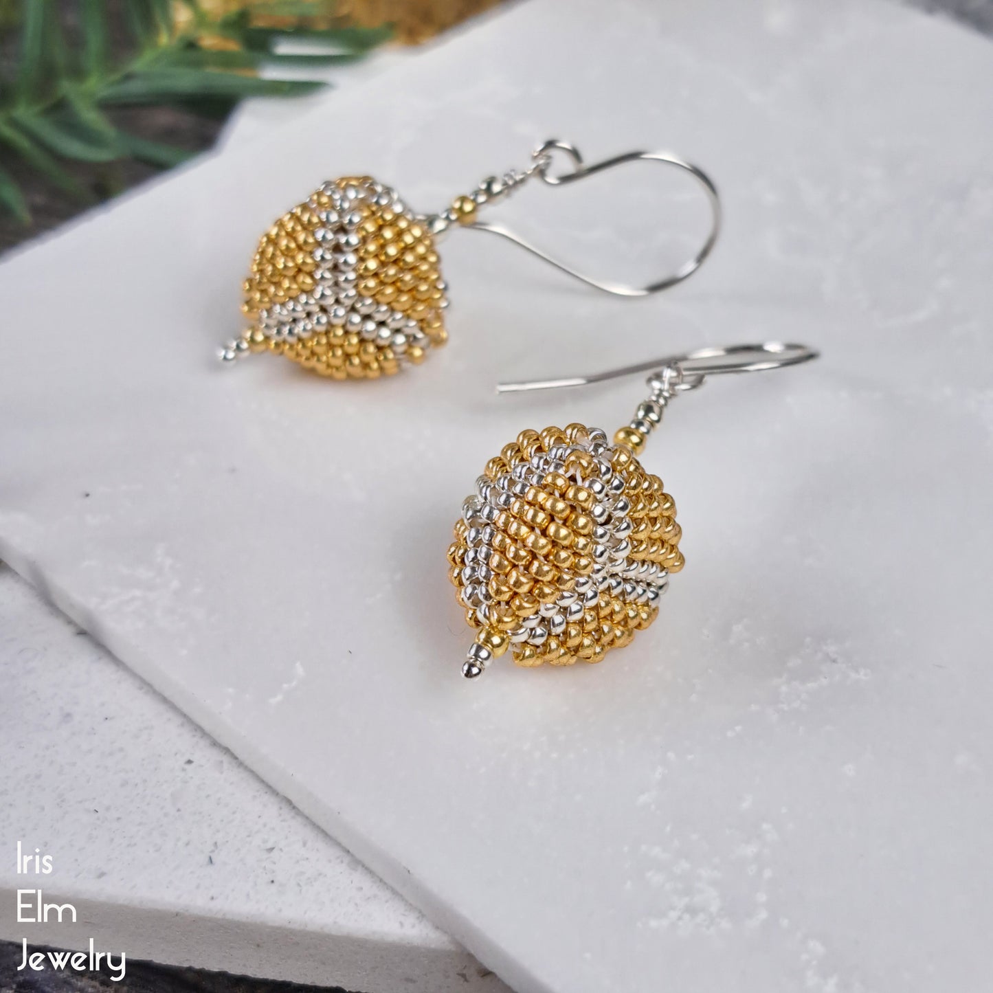 Gold and silver seed bead triangle beaded sterling silver earrings on a white surface with 'Iris Elm Jewelry' branding.