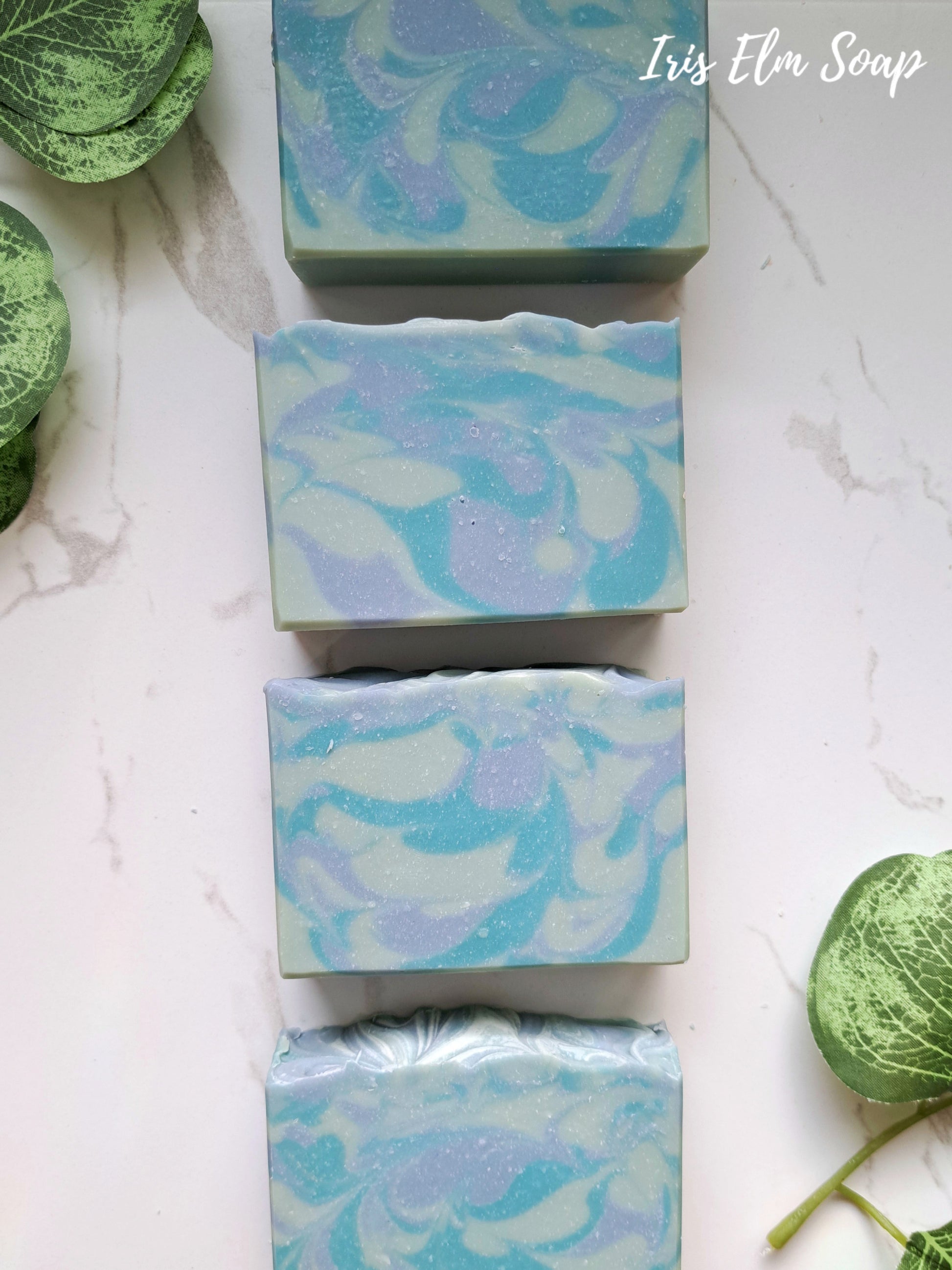 Marbled blue blueberry handmade soap bars on a light background with 'Iris Elm Soap' branding.