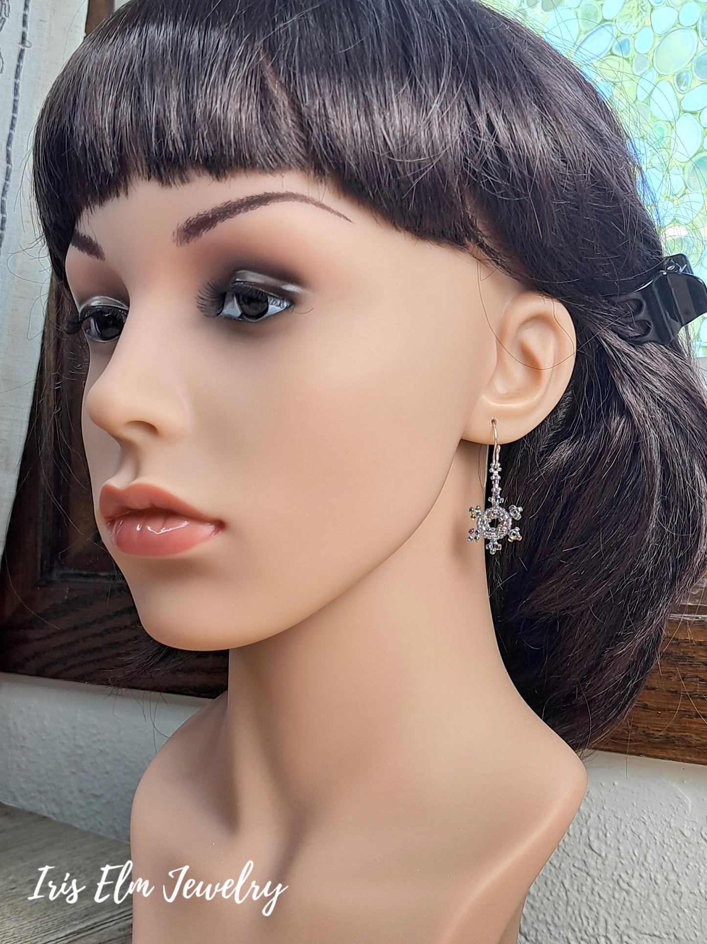 mannequin head wearing a snowflake earring