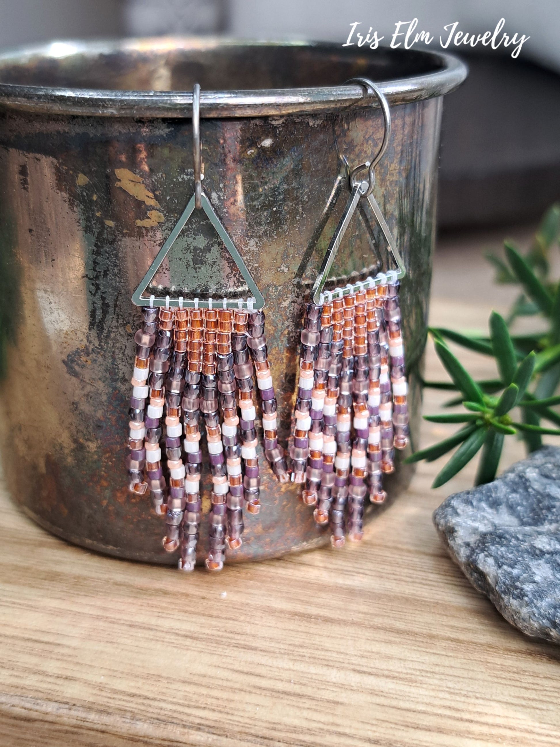 handmade small seed bead handwoven purple and copper orange seed bead fringe earrings with Iris Elm Jewelry branding.