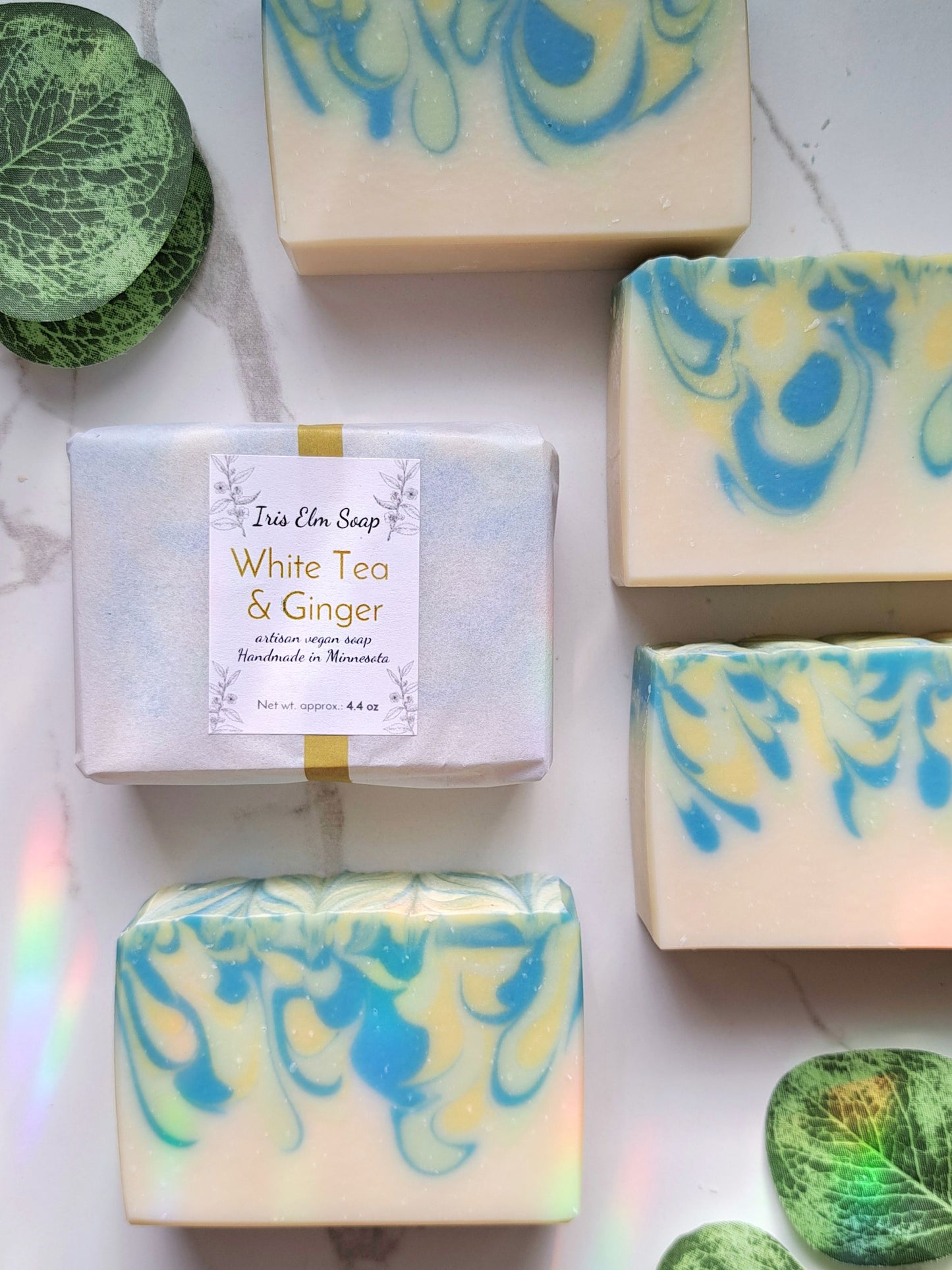 White Tea & Ginger soap bar with marbled design on a white surface