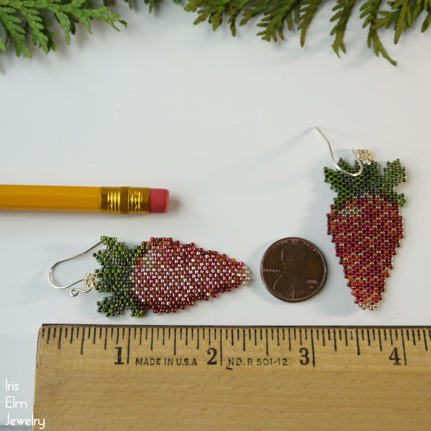 strawberry-shaped 2.25-inch-long beaded earrings next to a pencil and coin for scale, with 'This Elm Jewelry' branding.