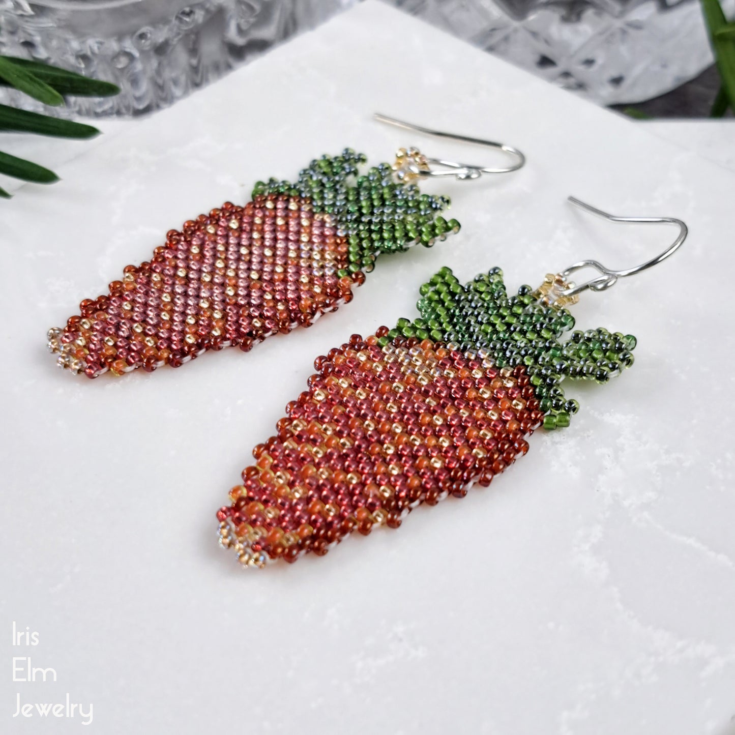 strawberry-shaped beaded earrings on a white surface with 'Iris Elm Jewelry' branding.