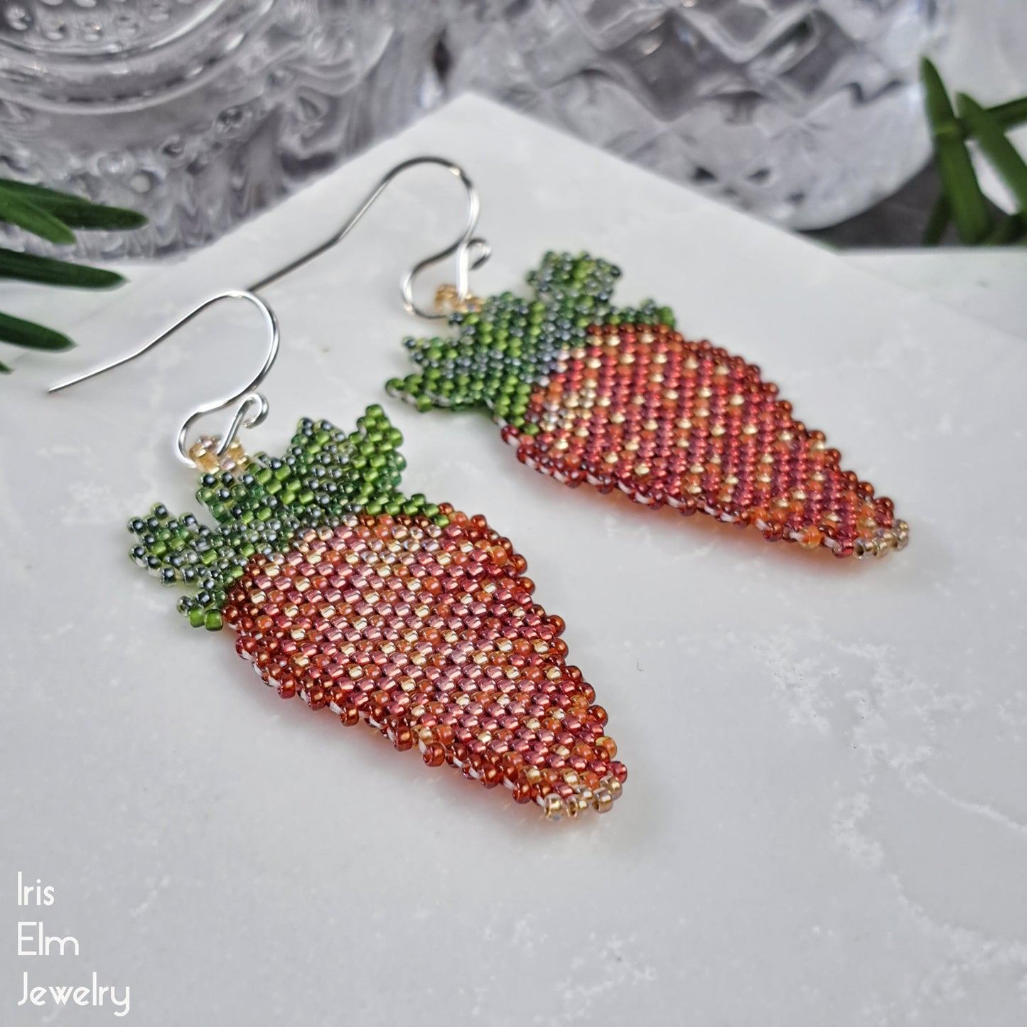 strawberry-shaped beaded red earrings on a white surface with 'Iris Elm Jewelry' branding.