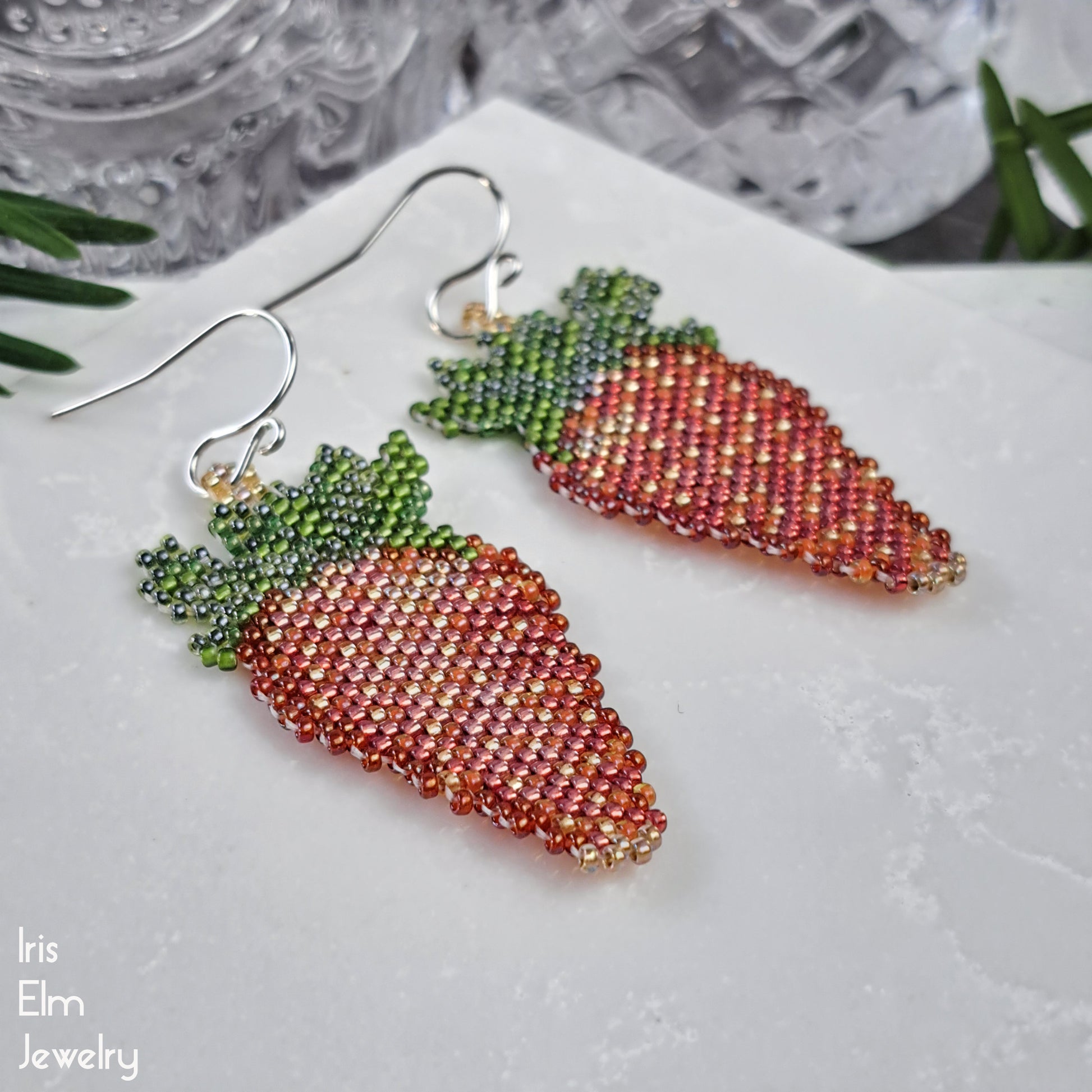 strawberry-shaped beaded red earrings on a white surface with 'Iris Elm Jewelry' branding.